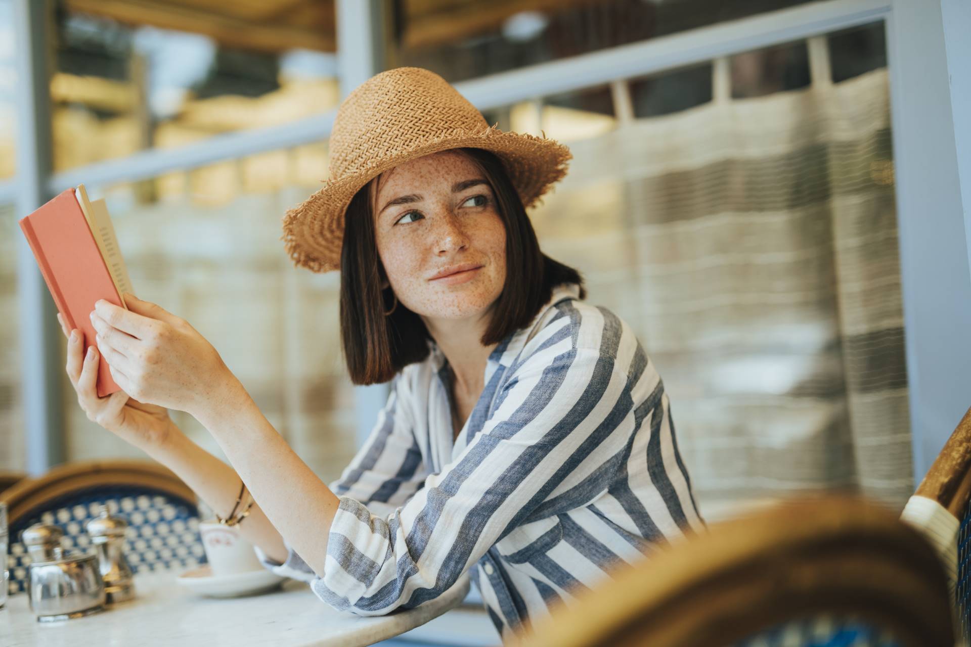 Woman reading a book at a cafe